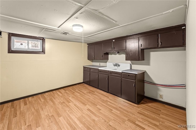 414 18th St, Niagara Falls, NY 14303 - kitchen with baseboards, dark brown cabinets, and light wood-style floors