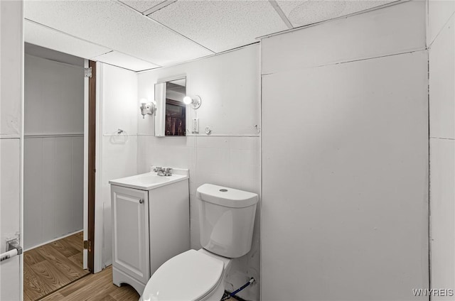 414 18th St, Niagara Falls, NY 14303 - half bath with toilet, wood finished floors, a drop ceiling, and vanity