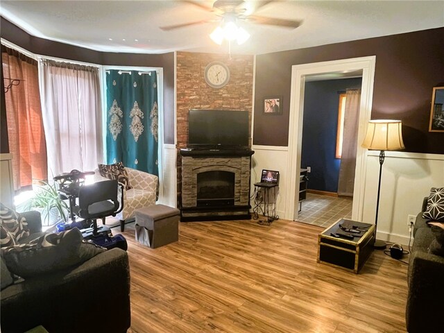 8 S St, Friendship, NY 14739 - living area featuring ceiling fan, wood finished floors, wainscoting, and a fireplace