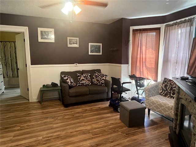 8 S St, Friendship, NY 14739 - living area with a wainscoted wall, a ceiling fan, and wood finished floors