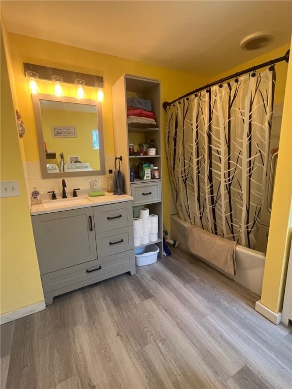 8 S St, Friendship, NY 14739 - full bathroom featuring wood finished floors, vanity, and shower / bathtub combination with curtain