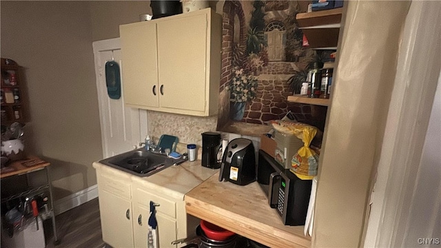 7 S 4th St, Fulton, NY 13069 - kitchen featuring a sink, light countertops, dark wood finished floors, white cabinets, and tasteful backsplash
