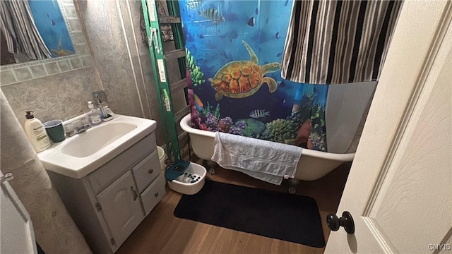 7 S 4th St, Fulton, NY 13069 - bathroom featuring vanity, wood finished floors, and a freestanding tub