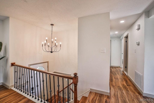 7025 Academy Ln, Lockport-Town, NY 14094 - hall with an upstairs landing, wood finished floors, baseboards, recessed lighting, and a textured ceiling