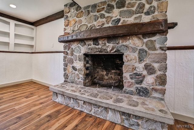 7025 Academy Ln, Lockport-Town, NY 14094 - detailed view of wood finished floors, wainscoting, and a stone fireplace