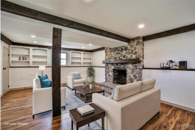 7025 Academy Ln, Lockport-Town, NY 14094 - living area featuring beam ceiling, wood finished floors, a stone fireplace, and recessed lighting