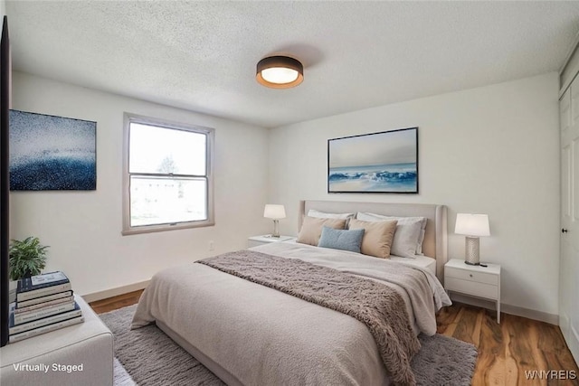 7025 Academy Ln, Lockport-Town, NY 14094 - bedroom featuring baseboards, wood finished floors, and a textured ceiling