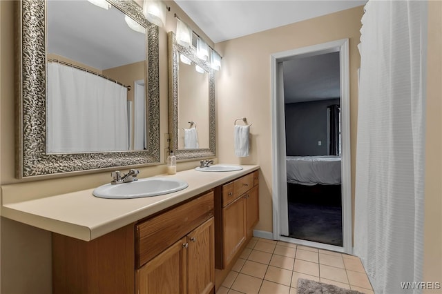 ensuite bathroom featuring tile patterned flooring and double vanity