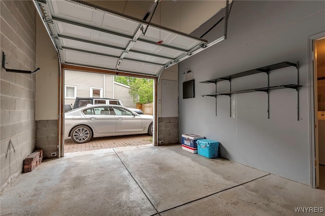 garage with concrete block wall