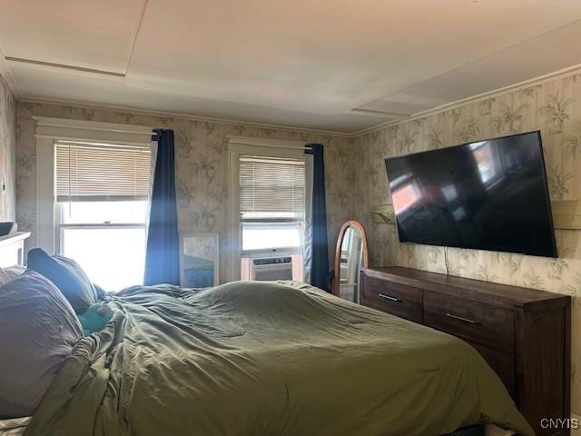 bedroom featuring wallpapered walls, cooling unit, and attic access