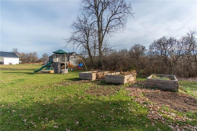 30622 Vanalstyne Rd, Clayton, NY 13622 - view of grassy yard featuring a garden and a playground