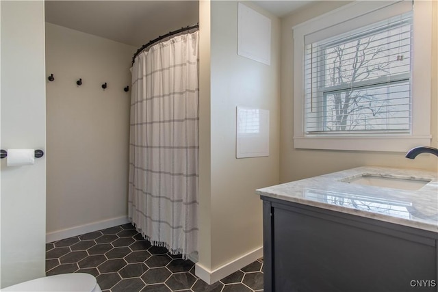 30622 Vanalstyne Rd, Clayton, NY 13622 - full bath with healthy amount of natural light, baseboards, toilet, and vanity