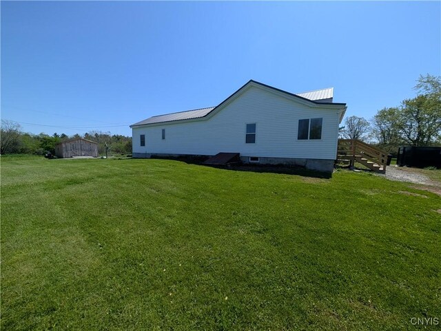 30622 Vanalstyne Rd, Clayton, NY 13622 - view of property exterior with a lawn and metal roof