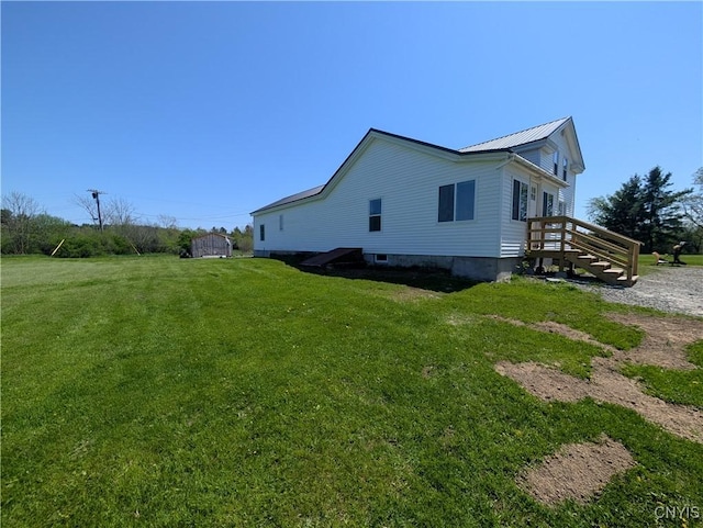 30622 Vanalstyne Rd, Clayton, NY 13622 - view of side of home featuring a yard and metal roof