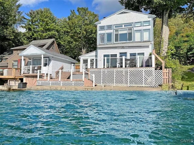 179 E Lake Rd, Deruyter, NY 13052 - rear view of house with a deck with water view