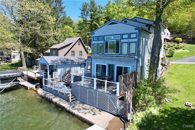 179 E Lake Rd, Deruyter, NY 13052 - rear view of house with a deck with water view, a lawn, and stairway