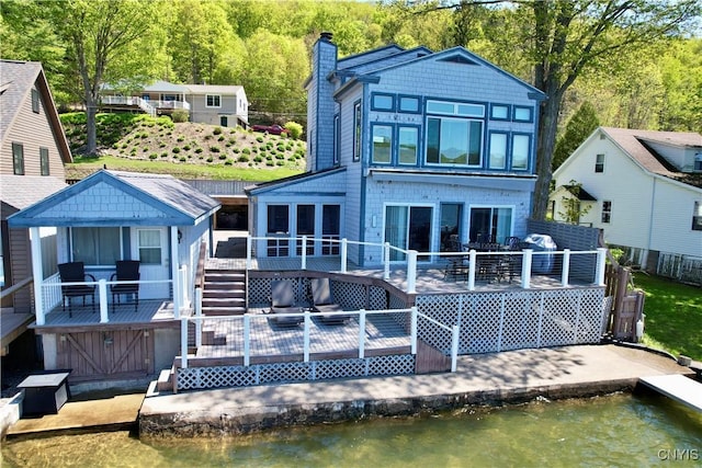 179 E Lake Rd, Deruyter, NY 13052 - back of property with a deck with water view and a chimney