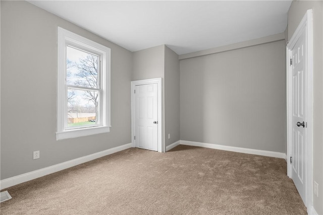 unfurnished bedroom with carpet and baseboards