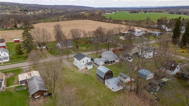 aerial view of property and surrounding area with rural landscape and nearby suburban area