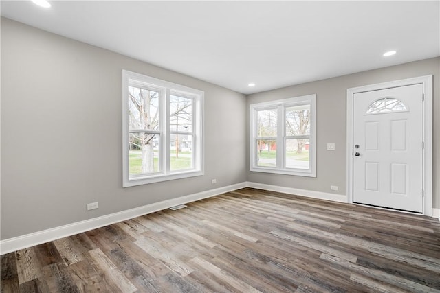 entryway with wood finished floors, baseboards, and recessed lighting