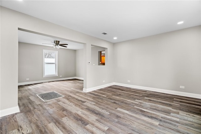 unfurnished room with wood finished floors, baseboards, recessed lighting, and a ceiling fan
