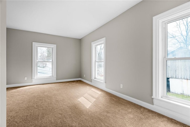 unfurnished room featuring carpet floors and baseboards