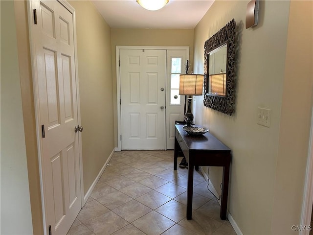 doorway to outside featuring baseboards