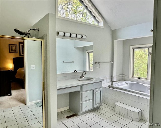 full bath with vaulted ceiling, tile patterned flooring, vanity, and a bath