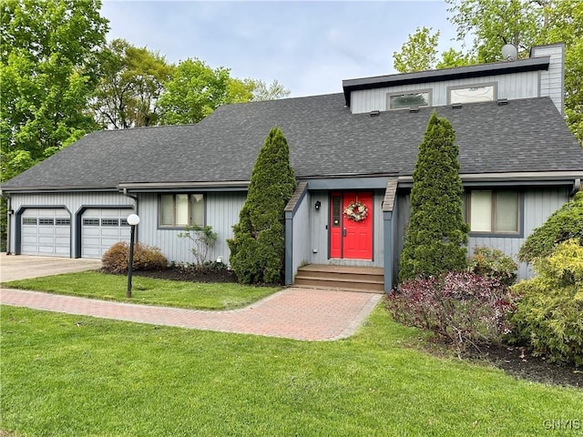 mid-century home featuring a shingled roof, a front lawn, a garage, and driveway