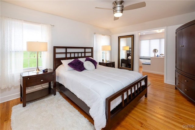 28 Lakeview Cir, Skaneateles, NY 13152 - bedroom featuring multiple windows, light wood-style floors, baseboards, and ceiling fan