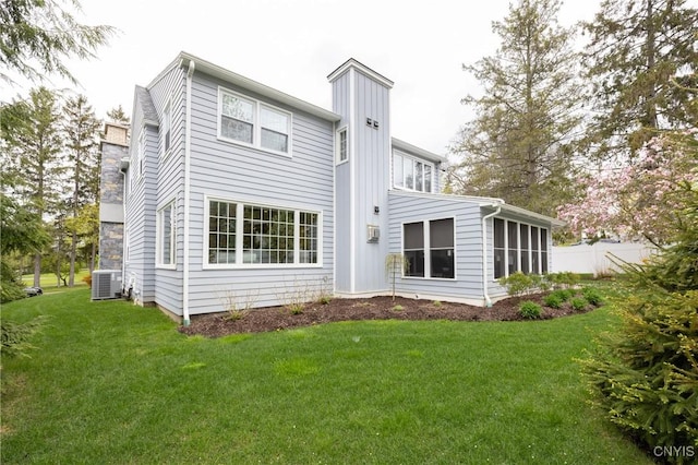 28 Lakeview Cir, Skaneateles, NY 13152 - back of house with a chimney, cooling unit, and a sunroom