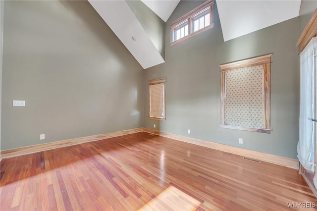 148 Mullen St, Tonawanda-City, NY 14150 - spare room featuring high vaulted ceiling, wood finished floors, and baseboards