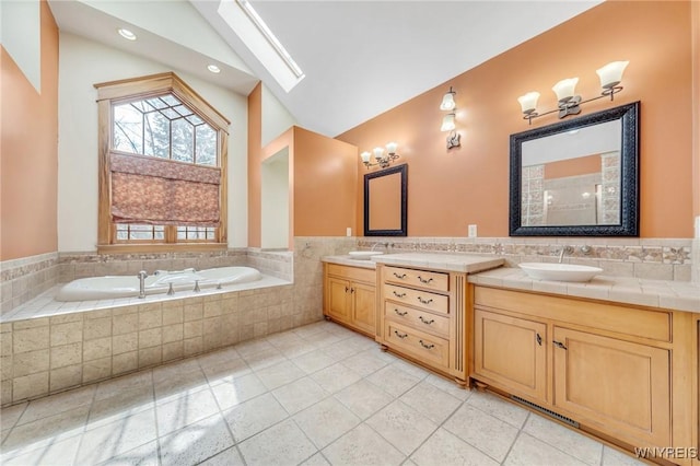 148 Mullen St, Tonawanda-City, NY 14150 - full bath featuring lofted ceiling, tile patterned flooring, a skylight, a bath, and double vanity