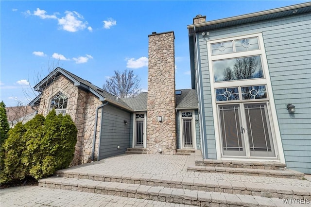 148 Mullen St, Tonawanda-City, NY 14150 - view of front of house featuring entry steps, a chimney, and a patio