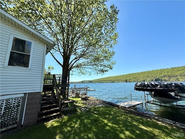 177 E Lake Rd, Deruyter, NY 13052 - dock featuring a water view, boat lift, and a wooded view