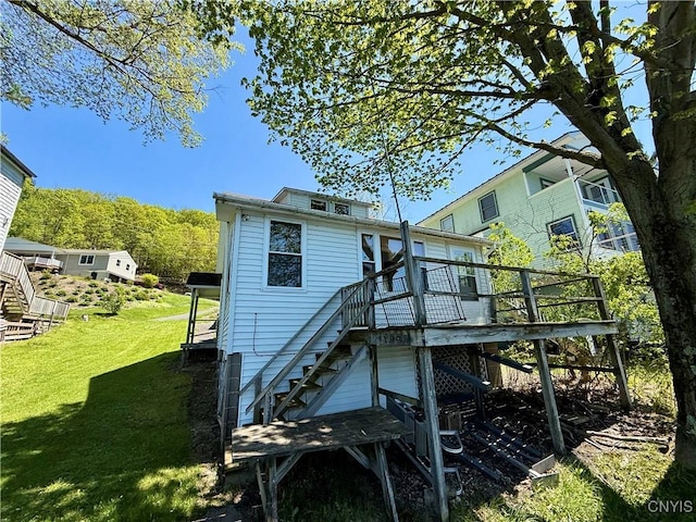 177 E Lake Rd, Deruyter, NY 13052 - back of property with stairway, a wooden deck, and a lawn