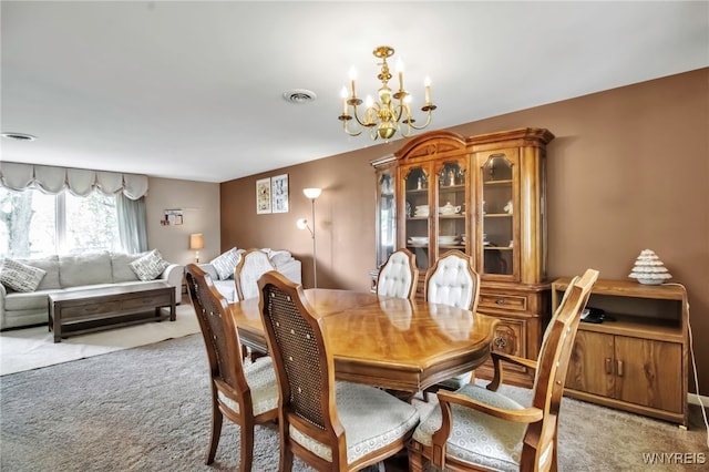 129 Summerview Rd, Amherst, NY 14221 - carpeted dining space with a chandelier