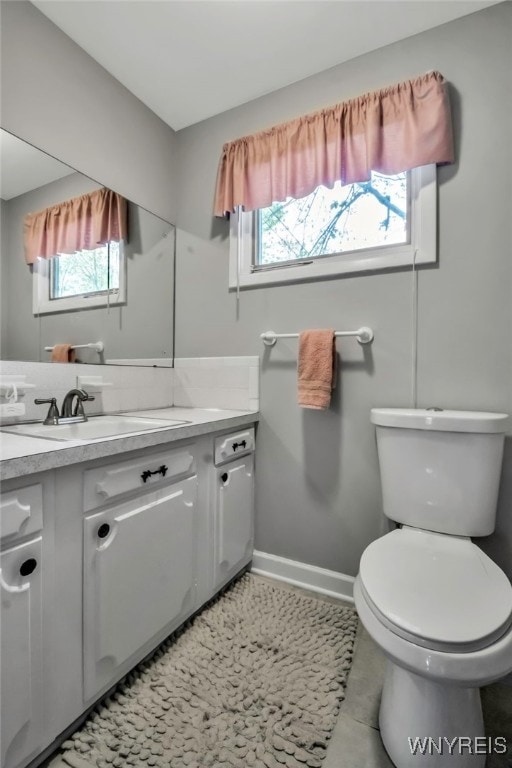 129 Summerview Rd, Amherst, NY 14221 - bathroom with plenty of natural light, toilet, and baseboards