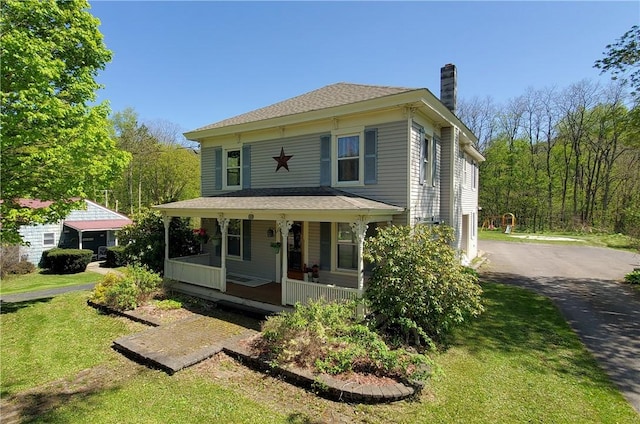 48 Division St, Maryland, NY 12155 - view of front of home featuring a porch, a chimney, a front yard, and asphalt driveway
