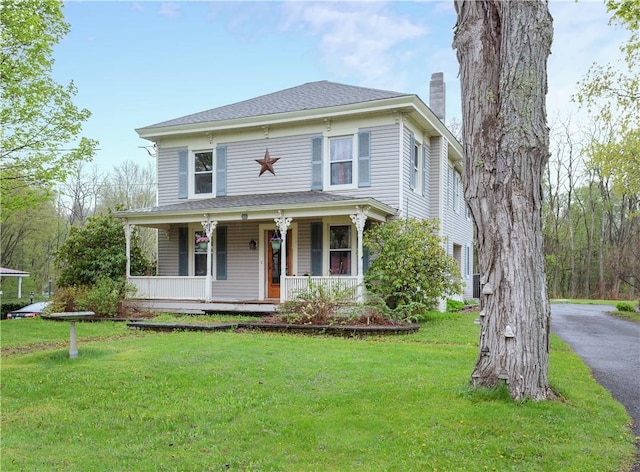 48 Division St, Maryland, NY 12155 - view of front of house with a chimney, covered porch, and a front lawn