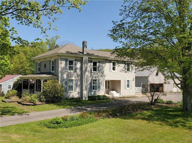 48 Division St, Maryland, NY 12155 - rear view of property with a yard, driveway, a chimney, an outdoor structure, and an attached garage