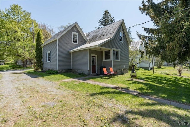 view of front facade with a front yard and metal roof