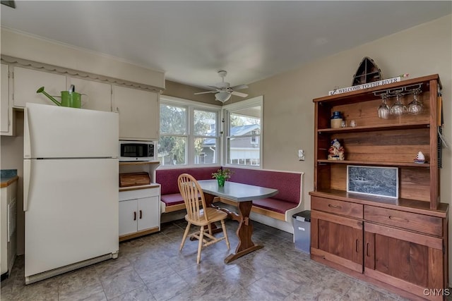 dining room featuring breakfast area and ceiling fan