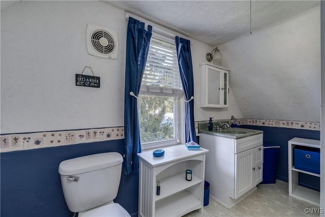 bathroom featuring toilet and vanity