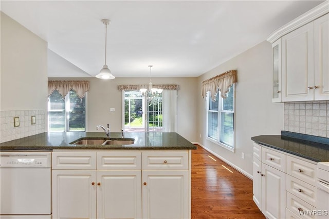 4179 Foxwood Ln, Clarence, NY 14221 - kitchen featuring dishwasher, a sink, white cabinets, hanging light fixtures, and wood finished floors
