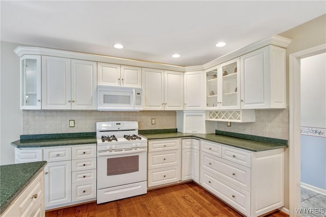 4179 Foxwood Ln, Clarence, NY 14221 - kitchen featuring white appliances, dark countertops, white cabinetry, decorative backsplash, and recessed lighting