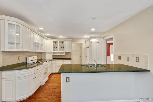 4179 Foxwood Ln, Clarence, NY 14221 - kitchen with white appliances, a sink, a peninsula, backsplash, and recessed lighting