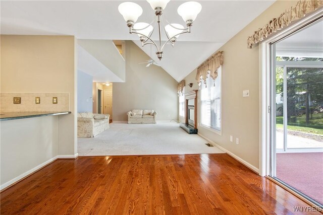 4179 Foxwood Ln, Clarence, NY 14221 - unfurnished dining area with a chandelier, plenty of natural light, wood finished floors, baseboards, and lofted ceiling