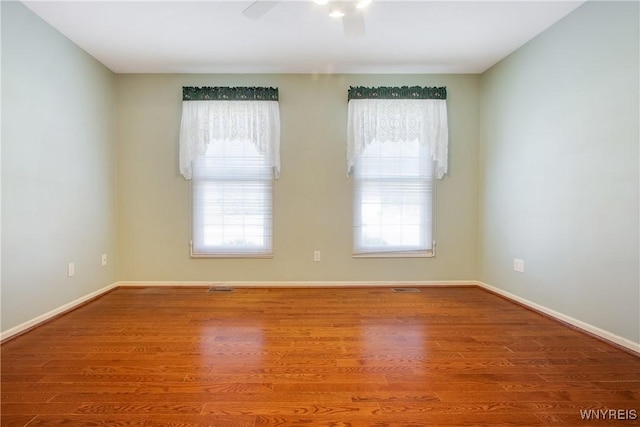 4179 Foxwood Ln, Clarence, NY 14221 - empty room featuring healthy amount of natural light, ceiling fan, and wood finished floors