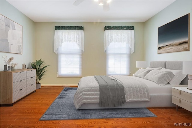 4179 Foxwood Ln, Clarence, NY 14221 - bedroom featuring multiple windows, wood finished floors, and ceiling fan